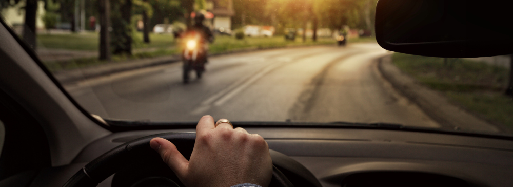 Oncoming motorcyclist seen from inside car